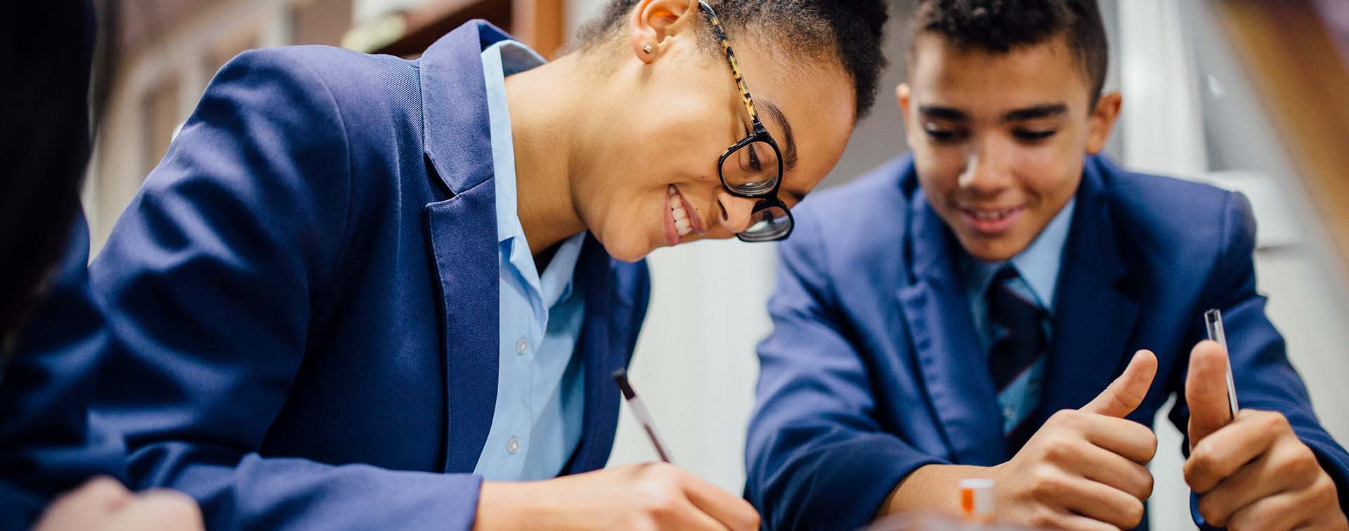 Smiling students doing homework
