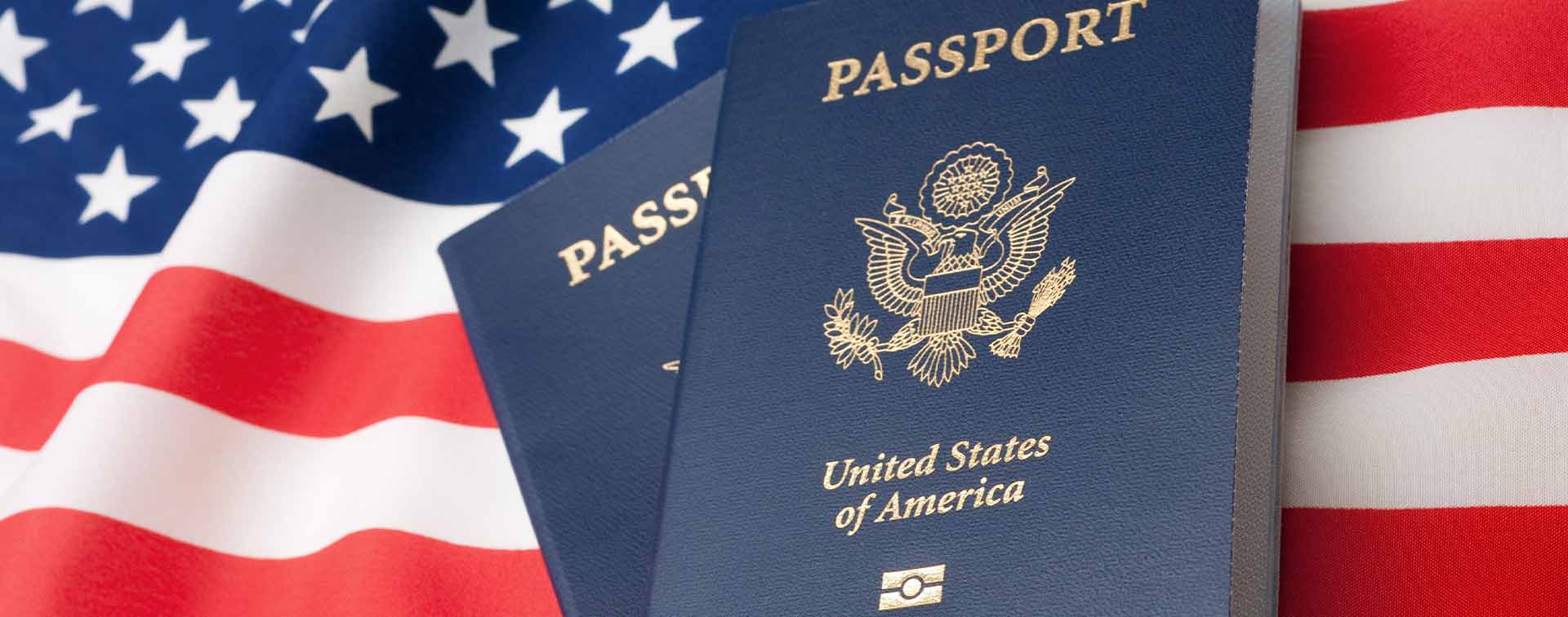 United States of America passport in front of the American flag