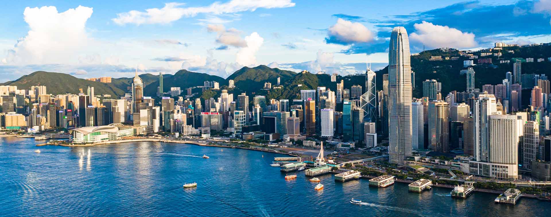 Drone view of Victoria Harbour, Hong Kong. Skyscraper buildings surrounded by water