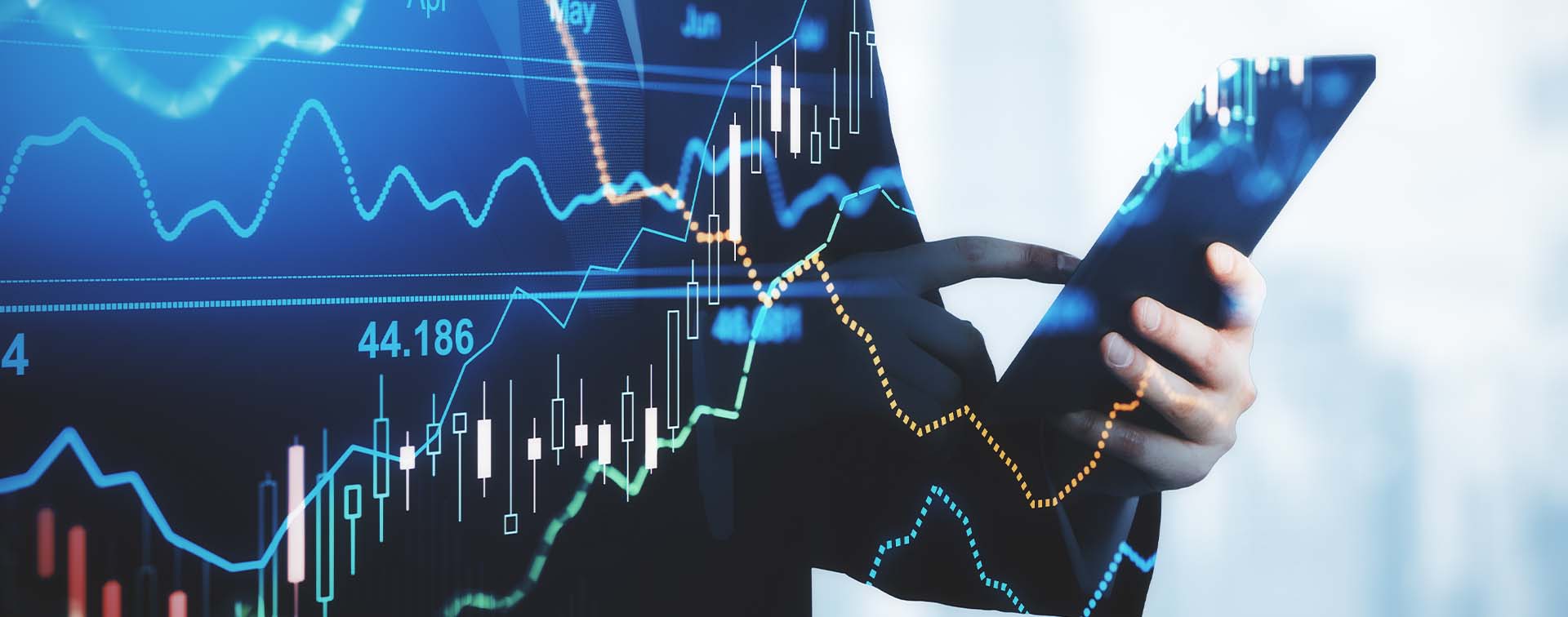 Trading and investment concept trader silhouette with digital tablet and virtual screen with financial chart graphs and candlestick