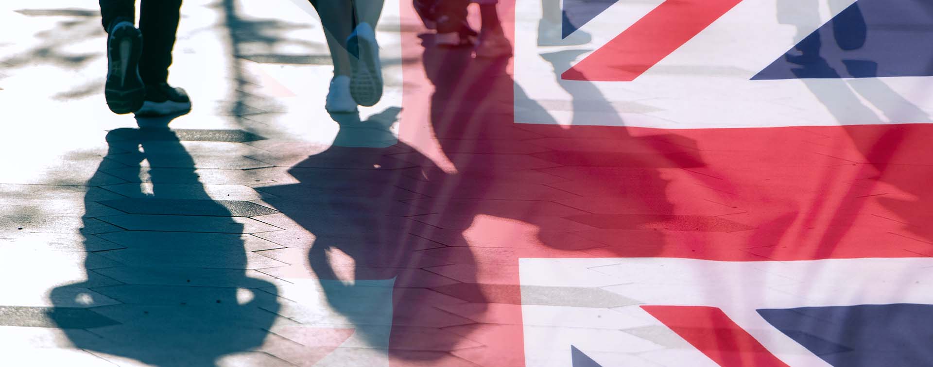  Shadows of people and UK flag citizens of Great Britain