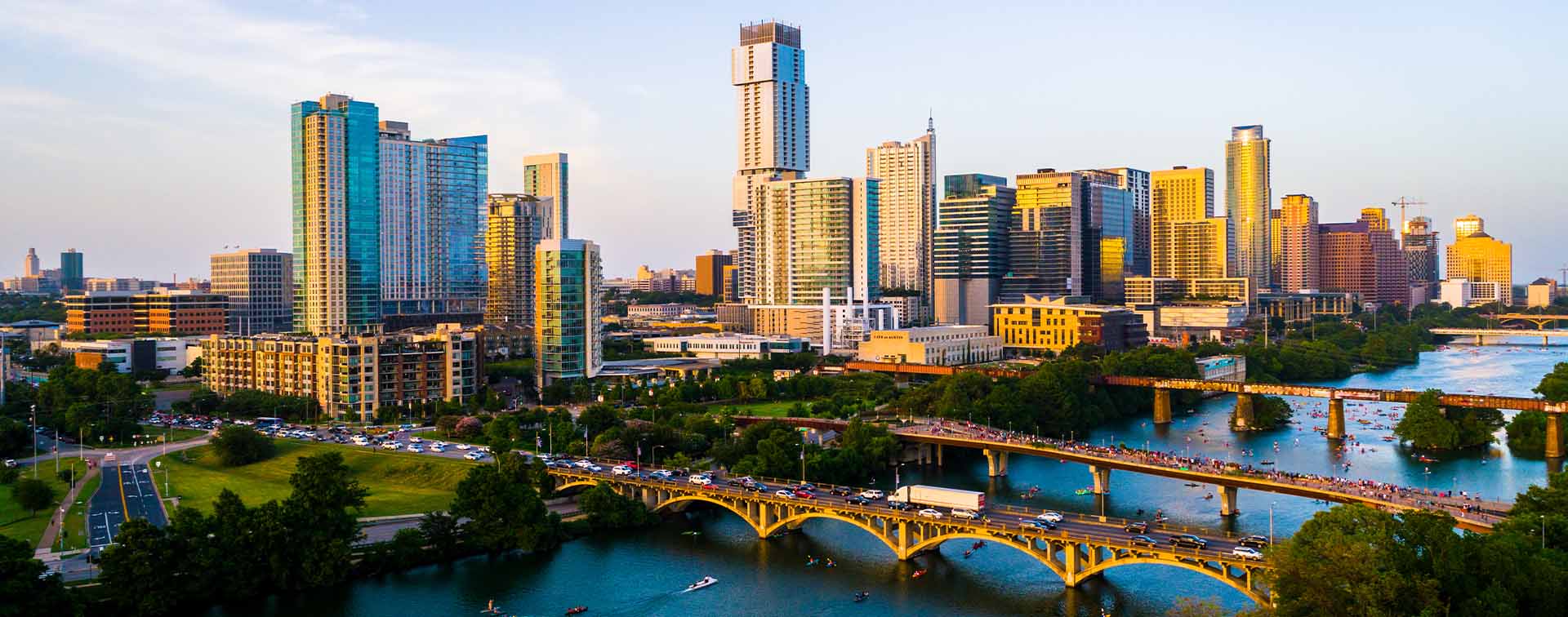 Austin, Texas, USA golden sunset over cityscape with river in foreground
