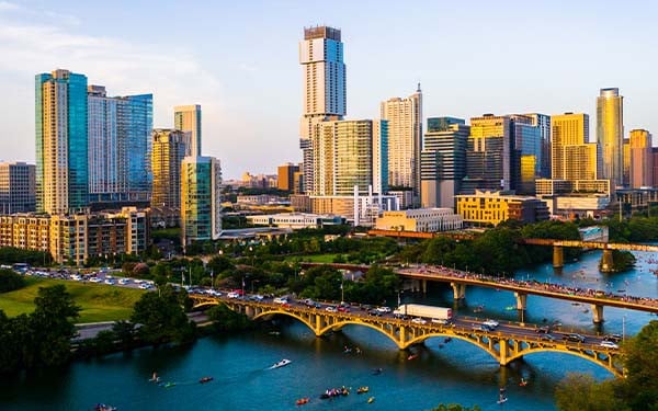 Austin, Texas, USA golden sunset over cityscape with river in foreground