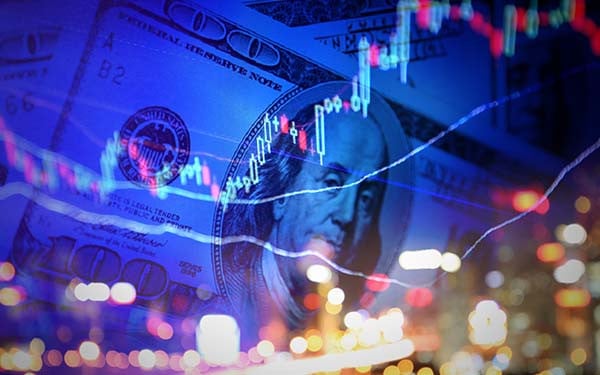 100 dollar note with stock market chart and city lights superimposed