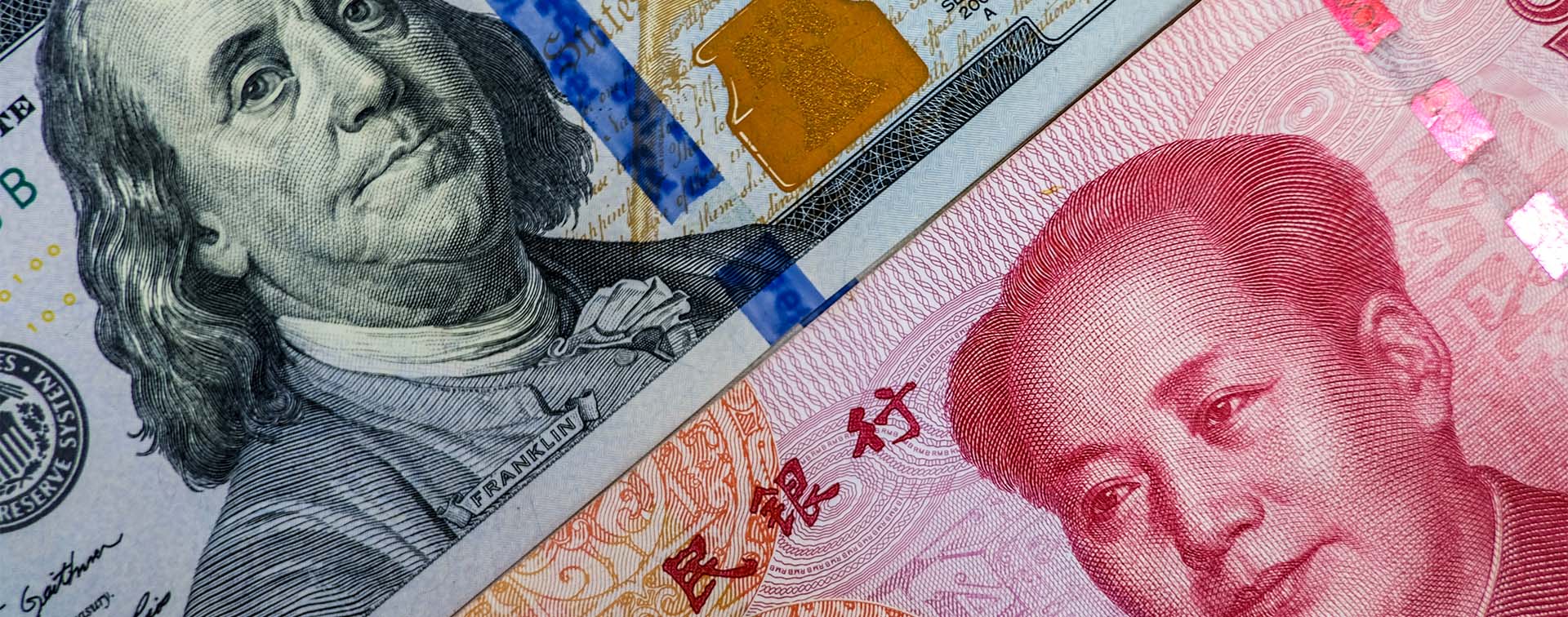 Face to face of US dollar banknote and China Yuan banknote