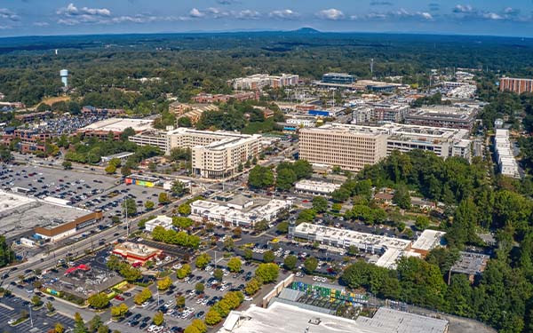Aerial view of the Atlanta suburb of Sandy Springs under a blue sky with tiny clouds in Georgia
